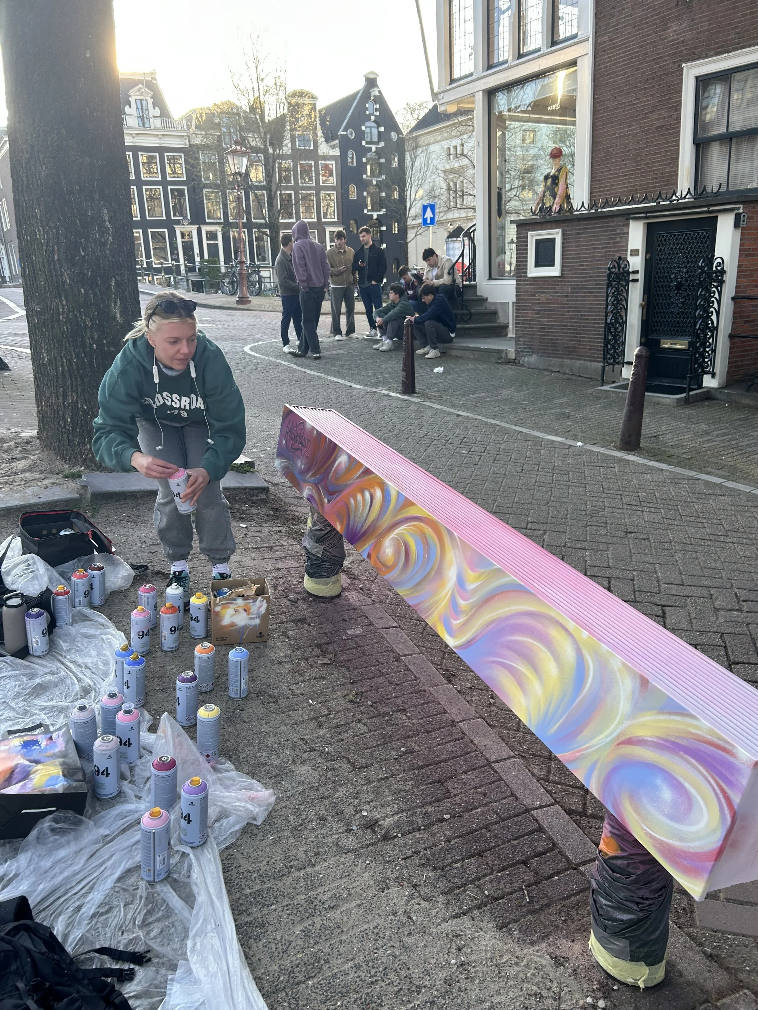 Amsterdam Female Street Artist Sames painting on Amsterdam Canals Keizersgracht