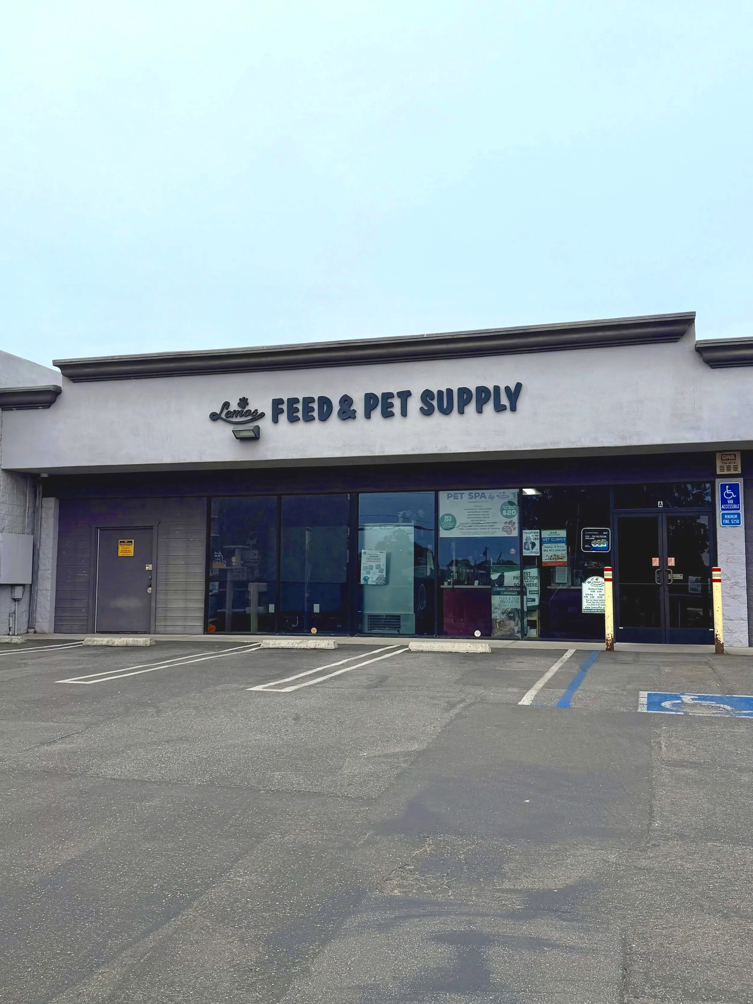 Exterior of a store called 'Lemos Feed & Pet Supply' in Los Osos with a parking lot in front and handicapped parking space visible.