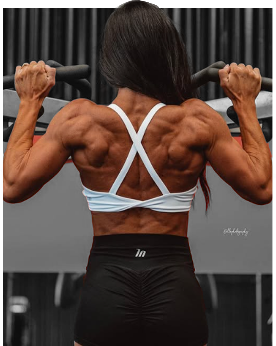 Jaydene performing pull-up exercise in gym with muscular back
