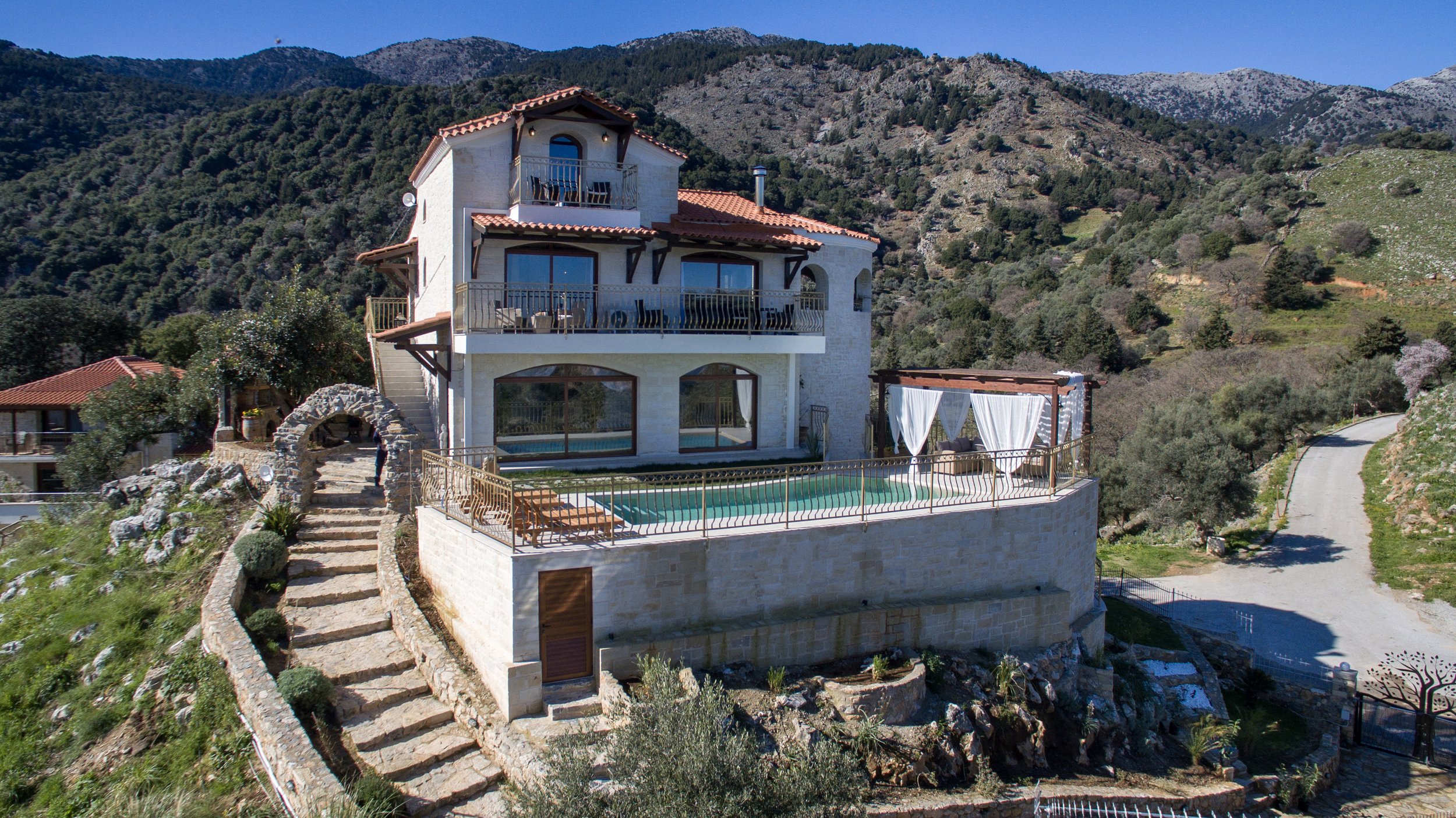 Hilltop villa with a pool and mountainous landscape