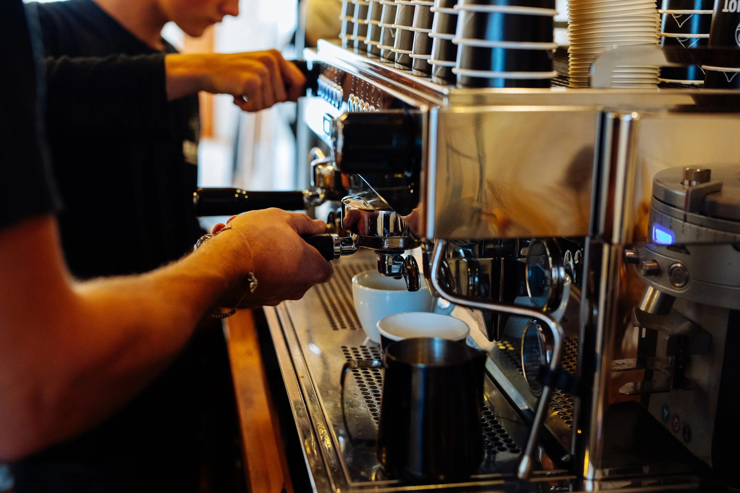 Image of coffee machine being operated in coffee shop