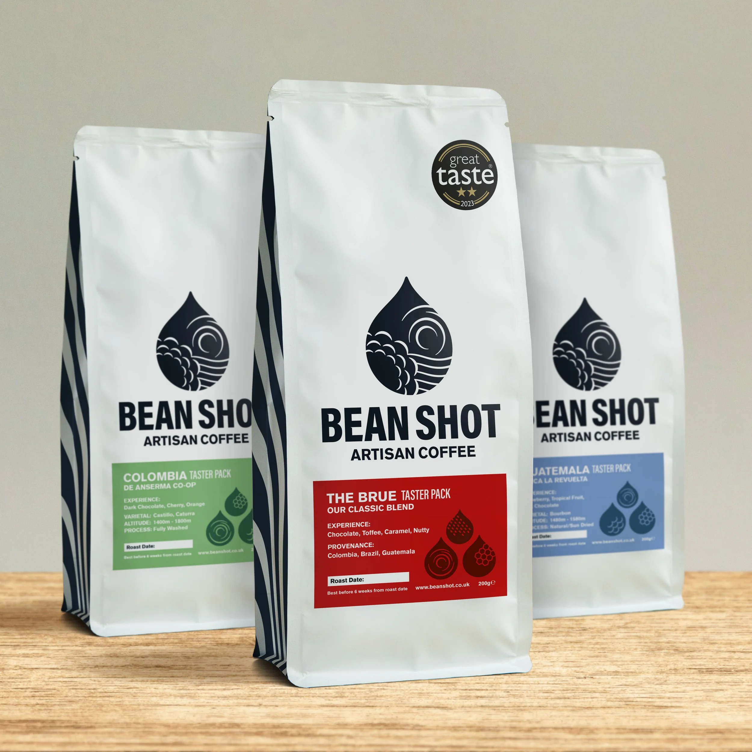 Colombia, The Brue and Guatemala Bean shot artisan roasted and sustainable taster bags of whole bean and ground coffee shown together at home on counter