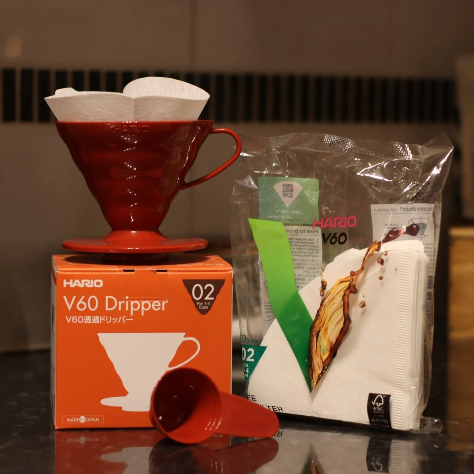 Red Hario V60 (02) and filters on kitchen counter