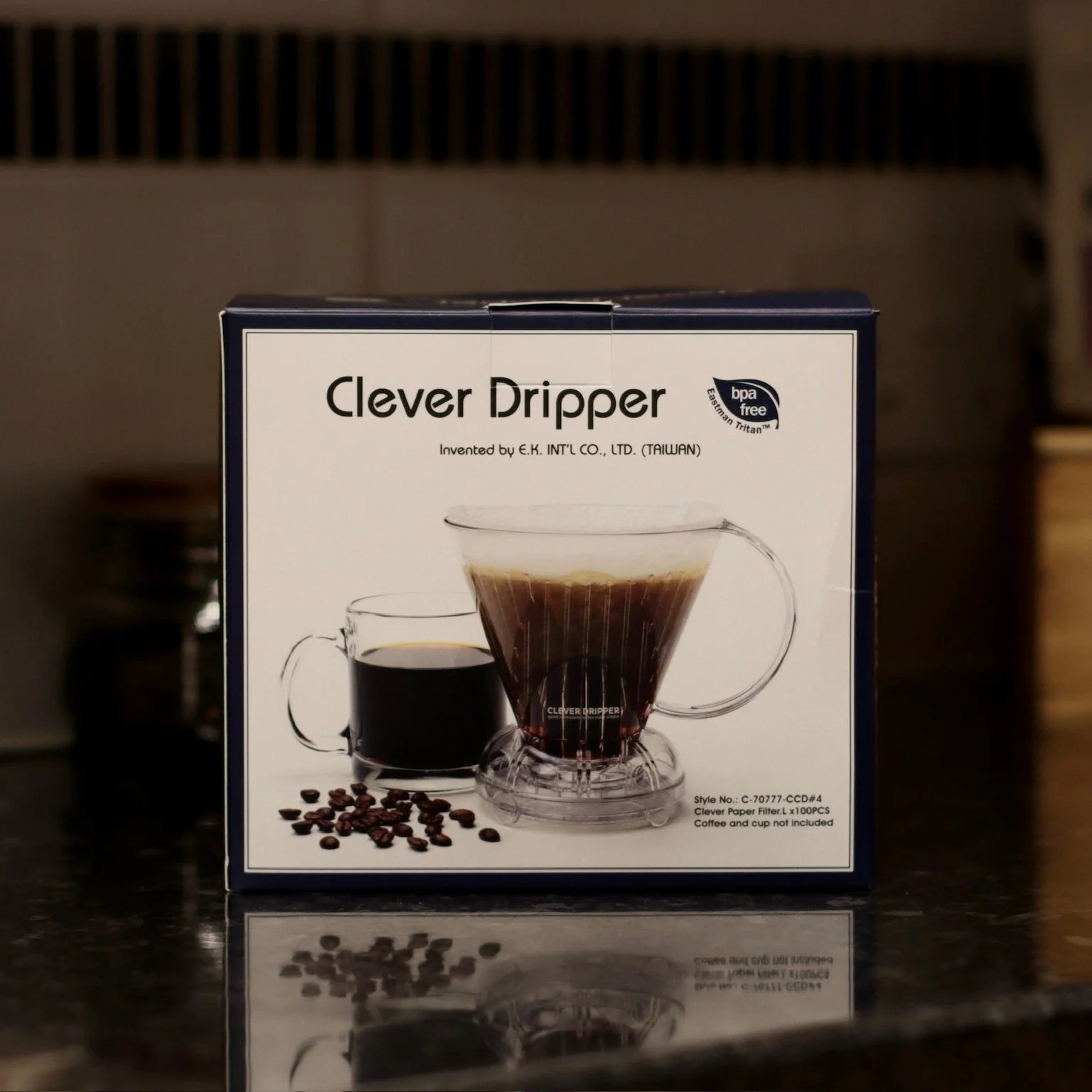 Clever coffee dripper in packaging on black kitchen worktop