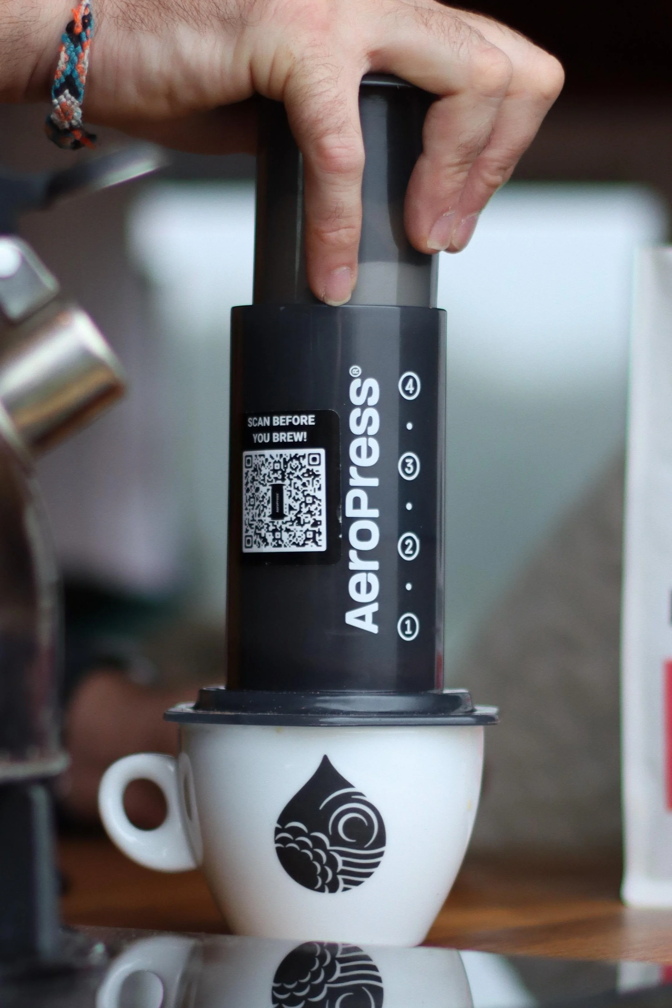 hand operating an aeropress making a coffee