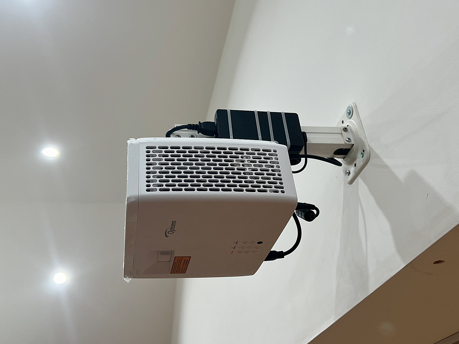Optoma projector mounted on the community hall wall