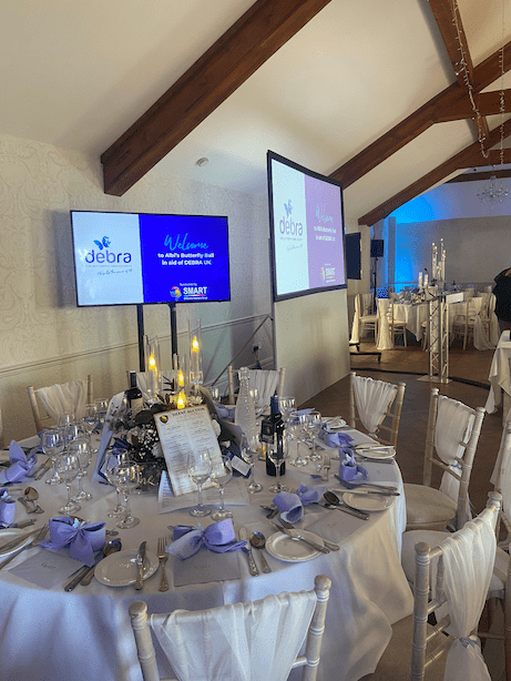 Debra event with TV screens and projector with set by Spartan AV in Cardiff