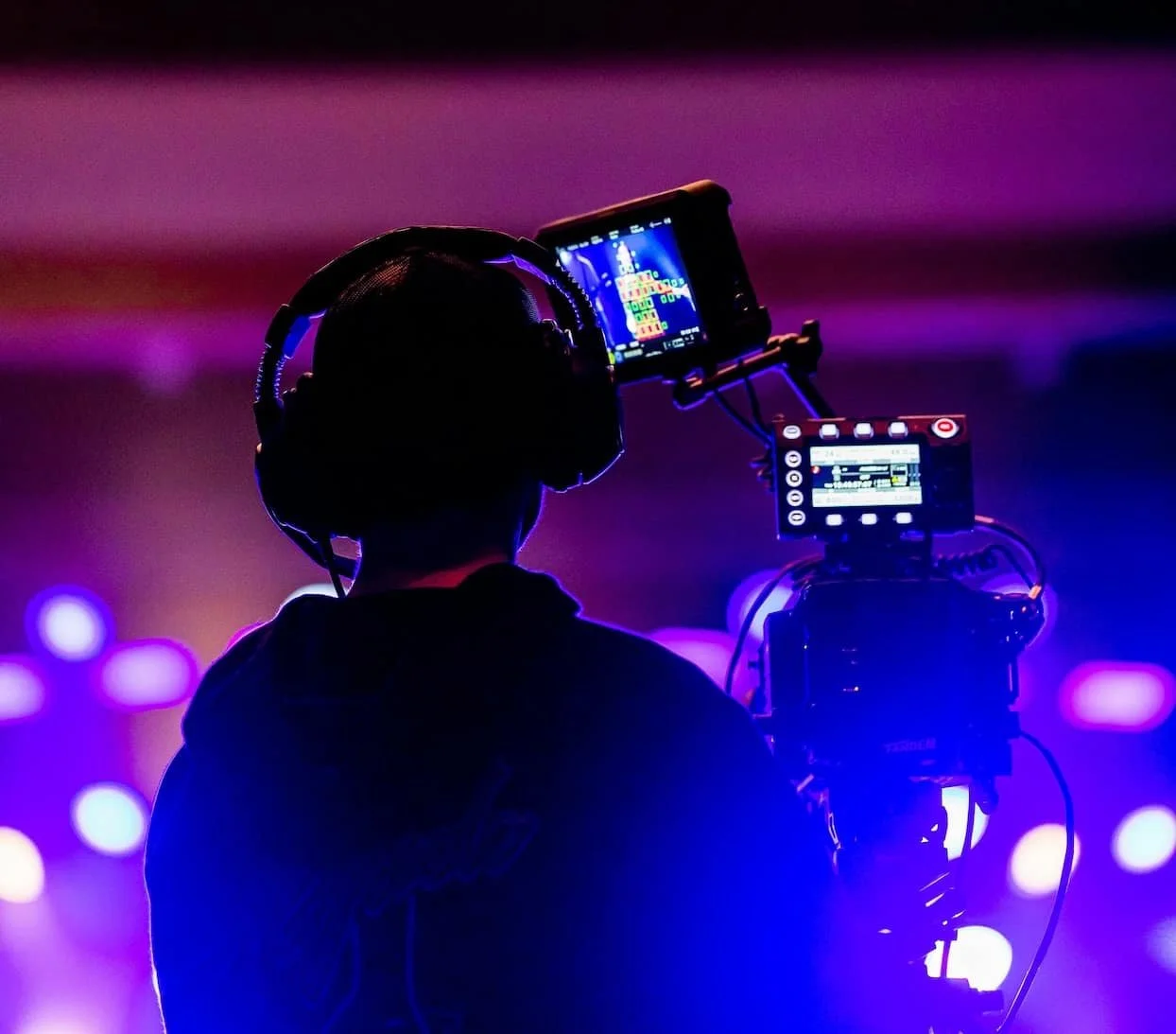 Camera operator capturing live action for big screens at awards show in Newport