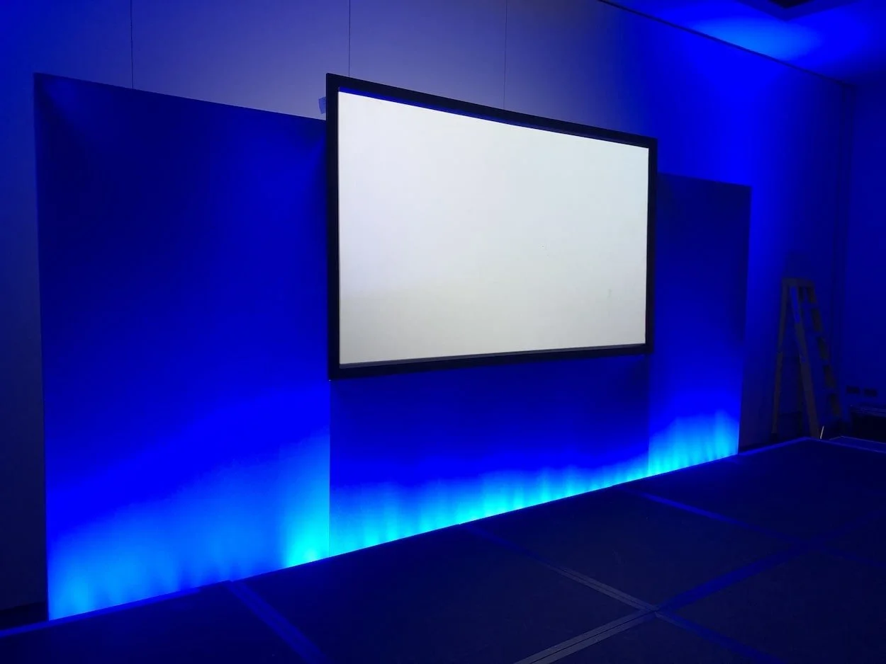 Staging for charity event. Big projector screen and lights. Equipment rental by Spartan Audio Visual