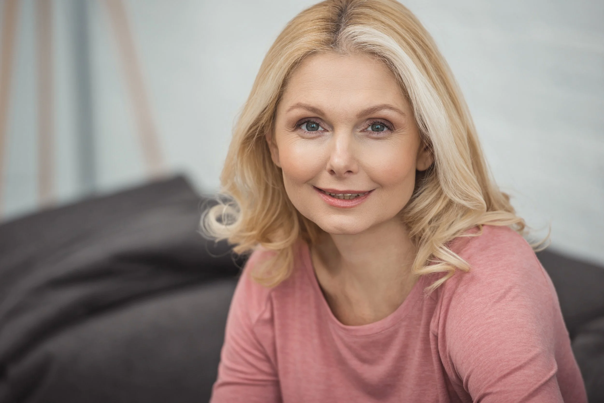 smiling-woman-in-pink-top-relaxing-indoors-2026-03-12-23-50-08-utc.jpg