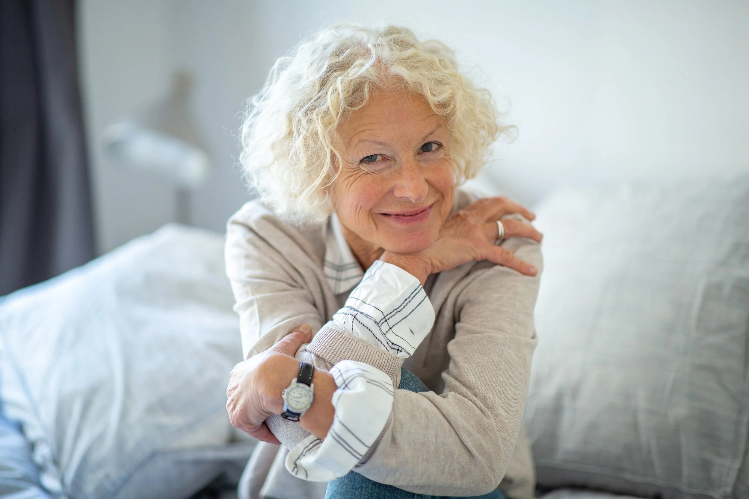 smiling-senior-woman-relaxing-in-bright-home-inter-2026-03-09-22-58-40-utc.jpg