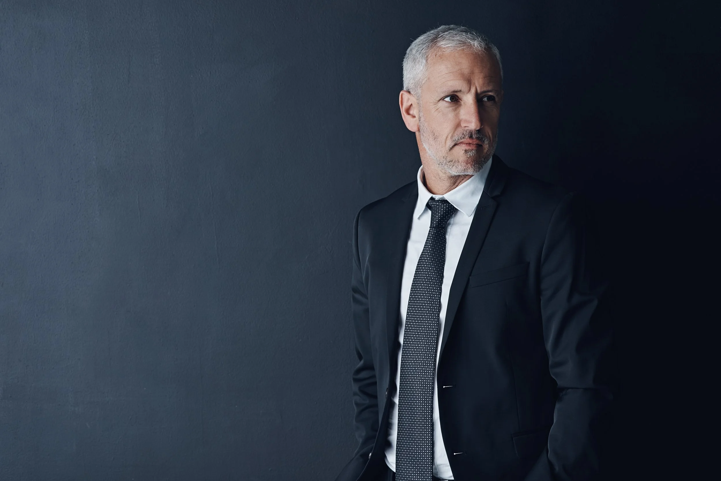 confident-man-in-suit-looking-off-camera-2026-03-25-05-36-24-utc.jpg