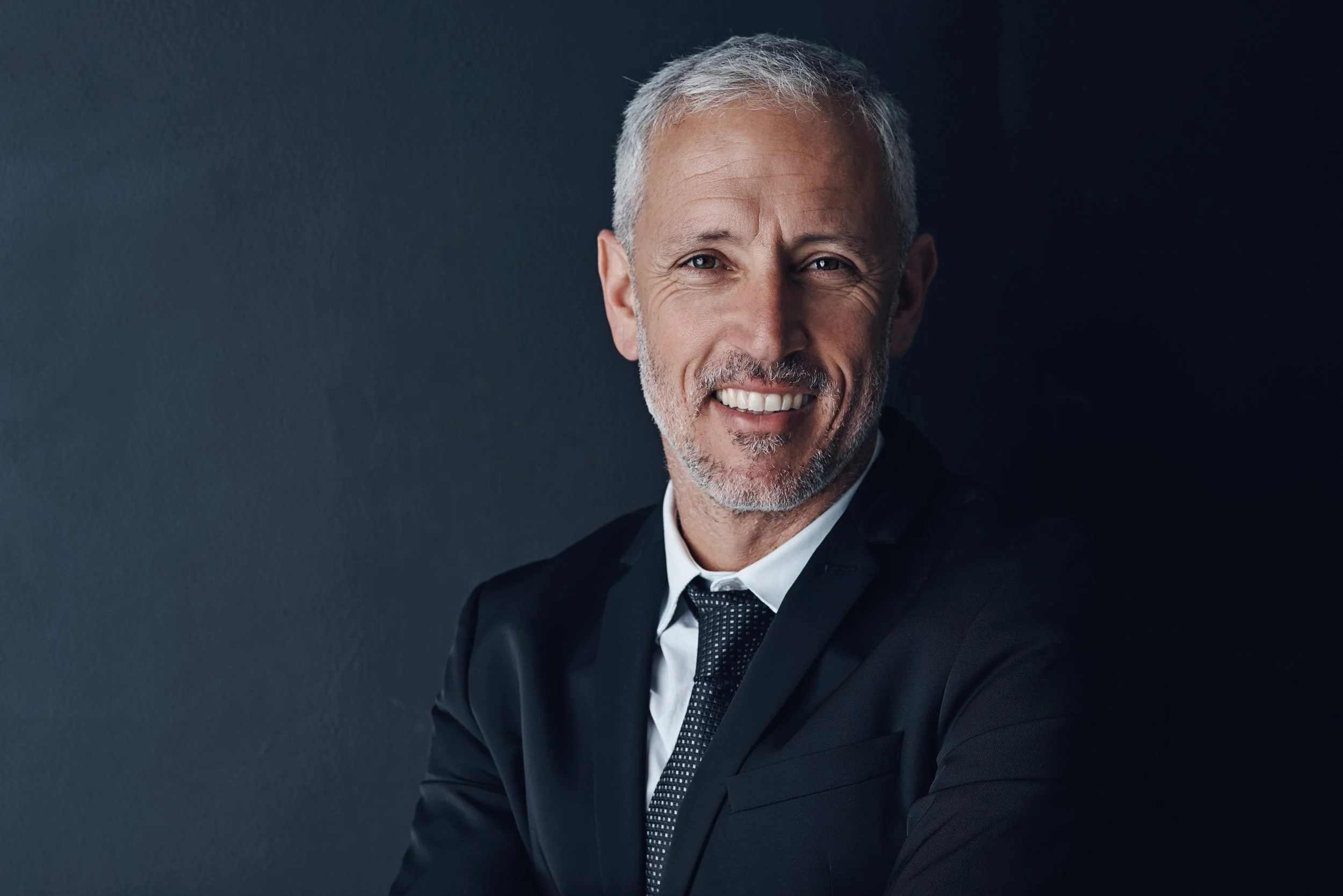 smiling-man-in-black-suit-and-tie-2026-01-09-09-35-34-utc.jpg