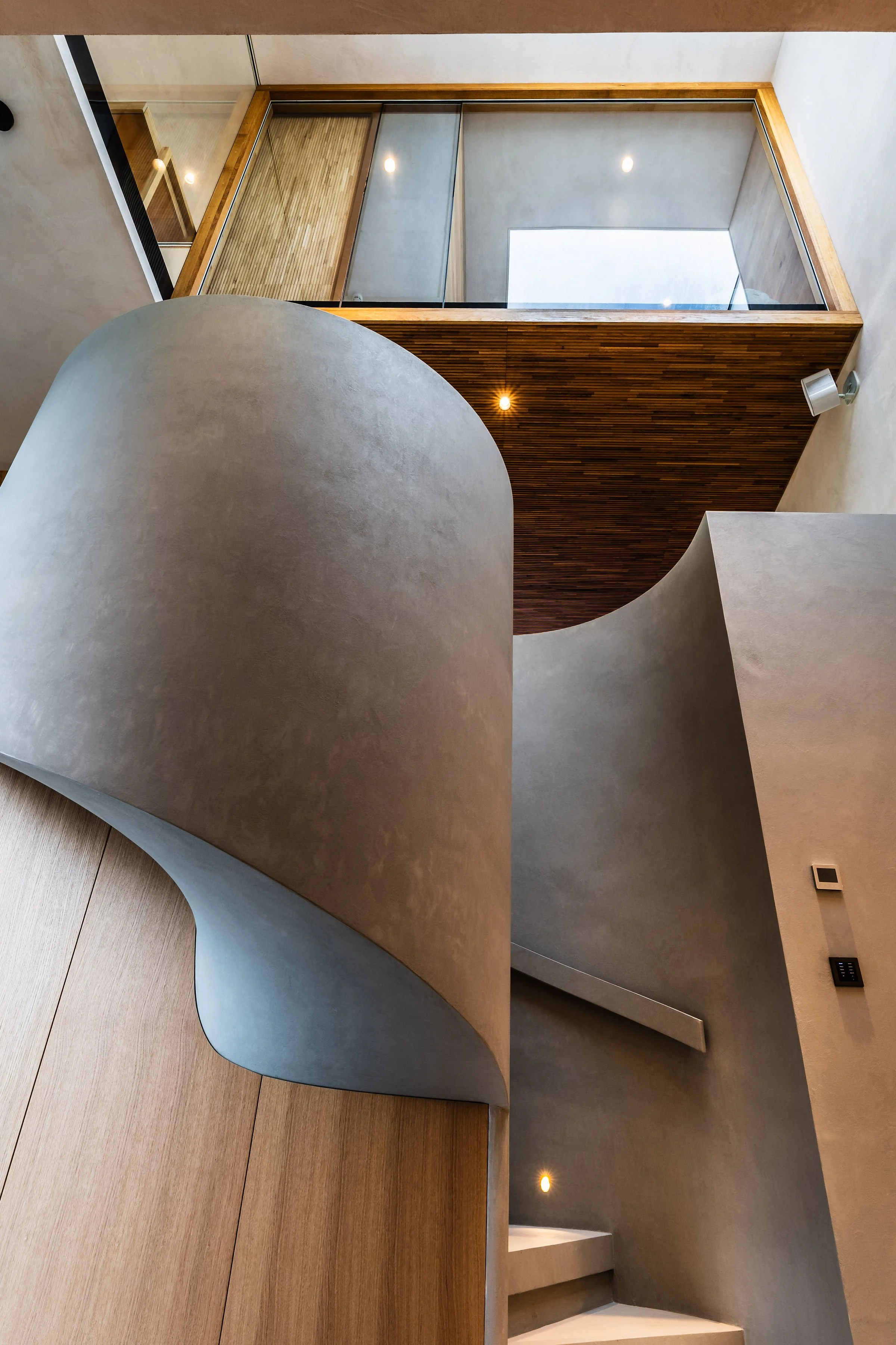 Spiral staircase with glazed oak above