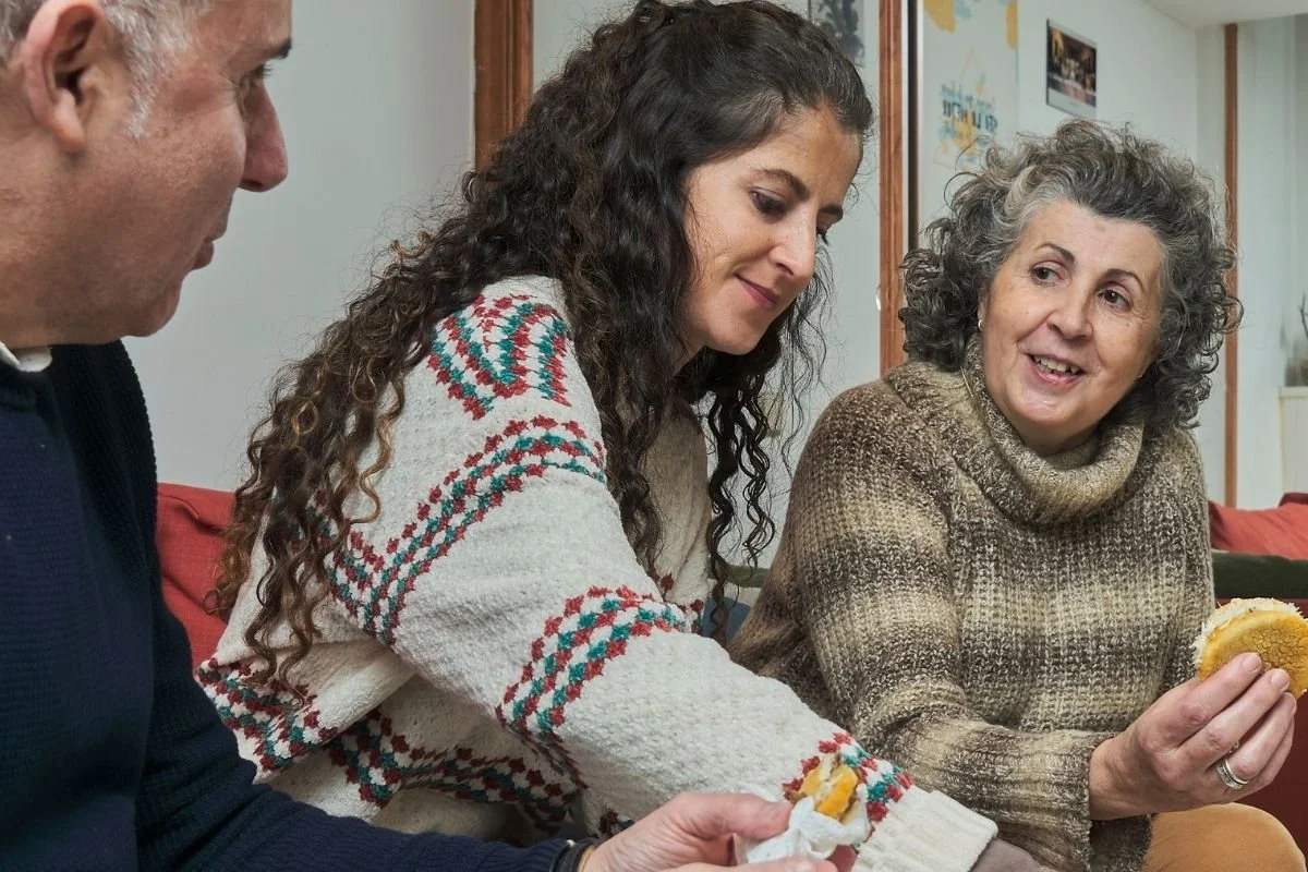 A man and two women chatting