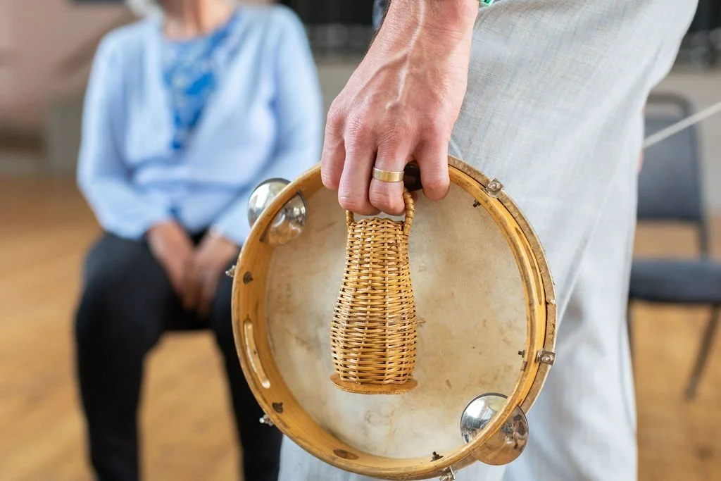 A hand holding a tambourine