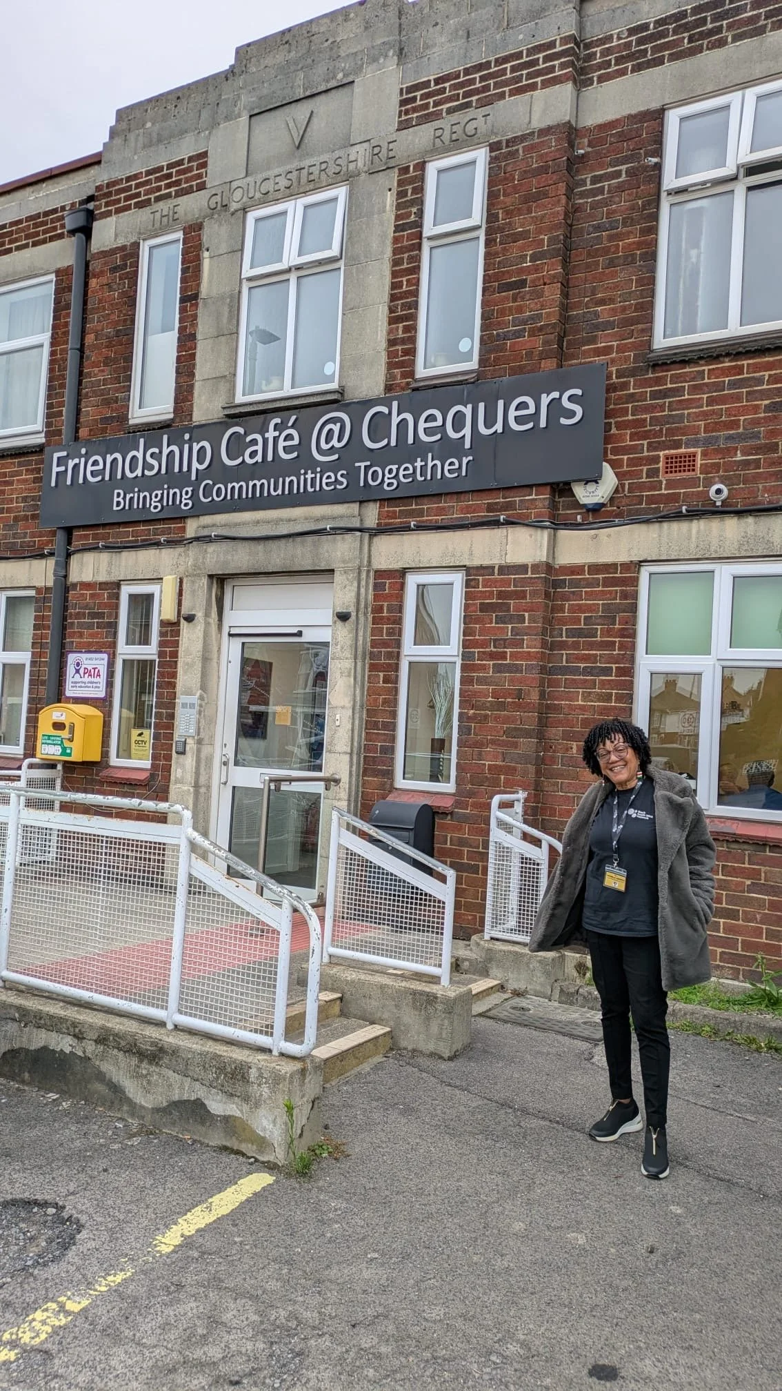 A woman standing outside a cafe