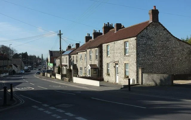 Terrace of stone houses along a road in Peasedown St John