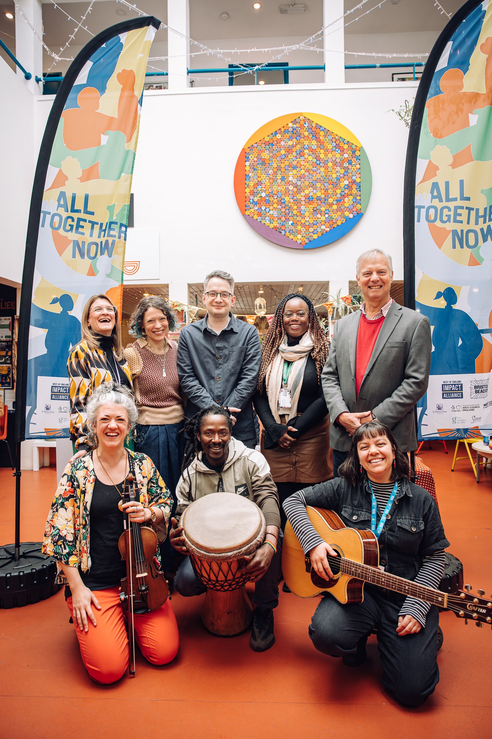 People celebrating the launch of All Together Now, some of them with musical instruments