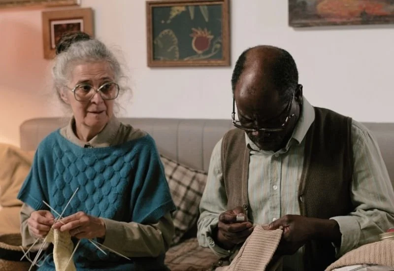 A woman and man knitting