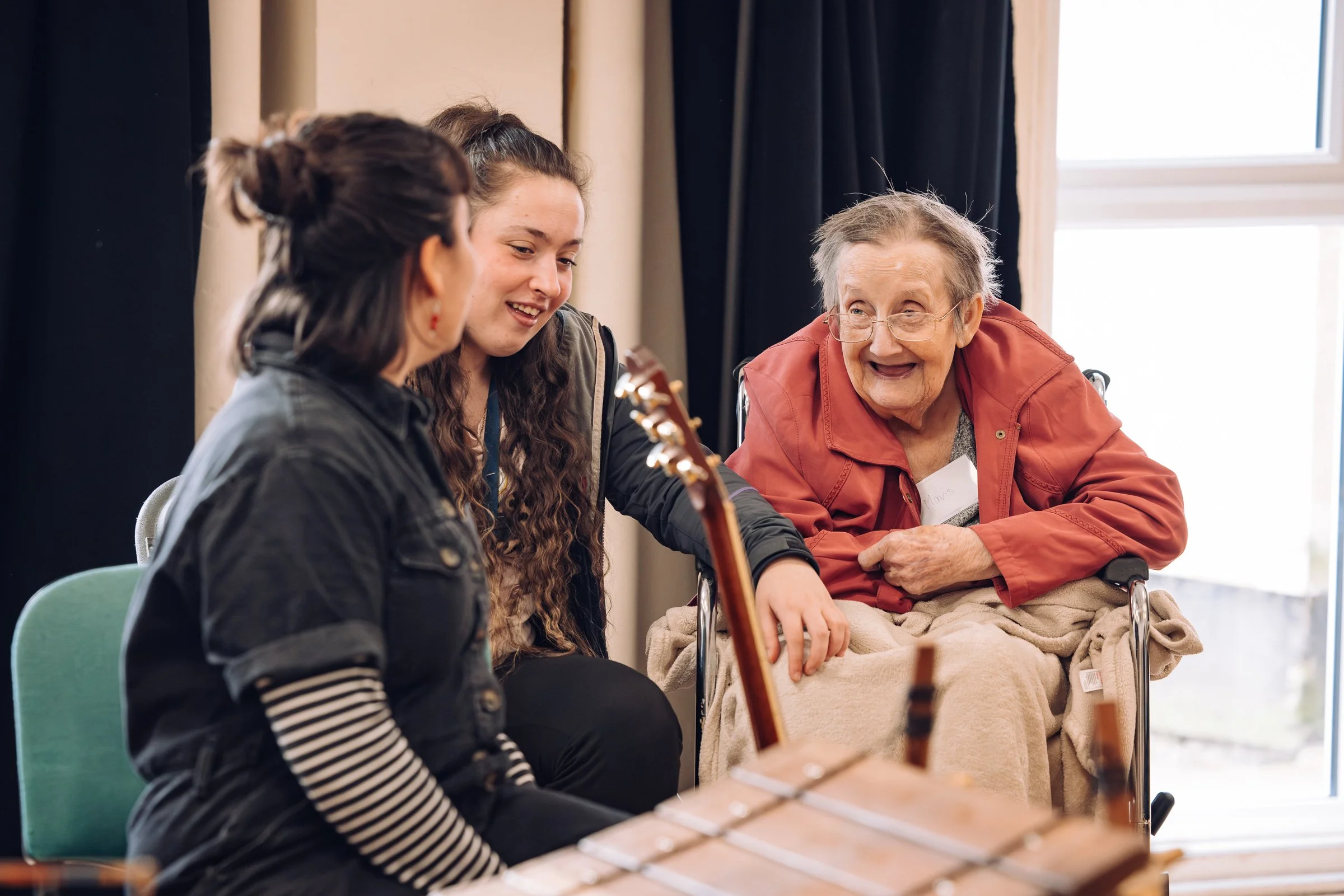 Three women, one an older woman, laughing together