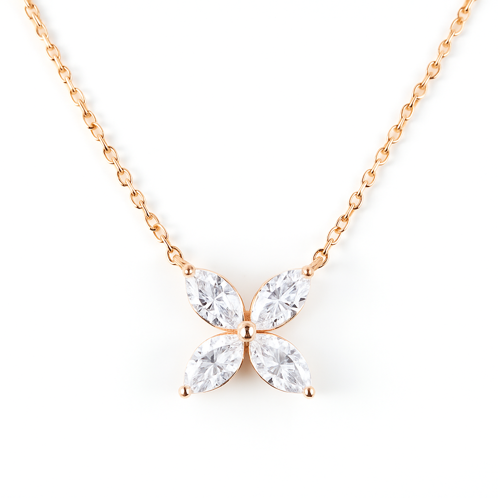A gold chain necklace with a butterfly-shaped pendant made of four large, clear gemstones.