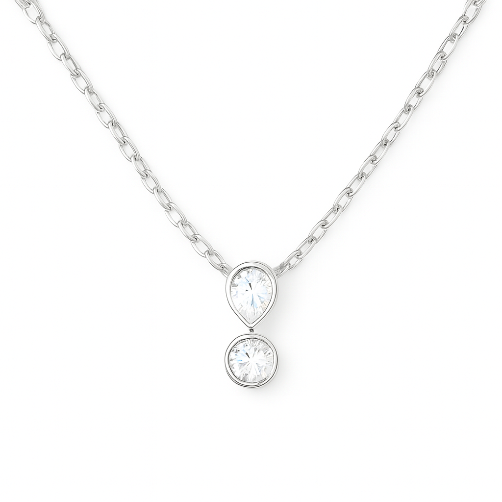 Silver necklace with a chain and two teardrop-shaped and round clear gemstones hanging in the middle.