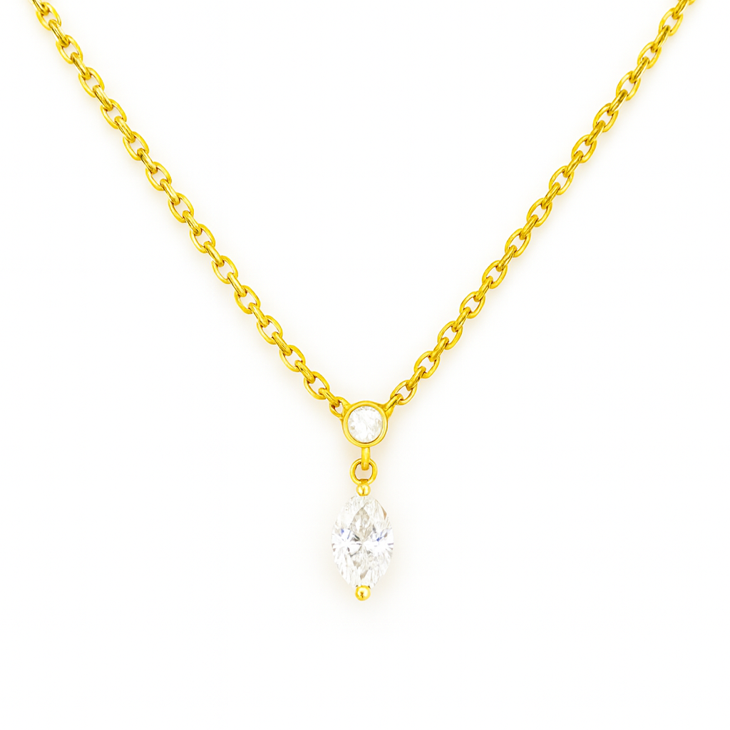 Gold chain necklace with a single clear gemstone pendant.