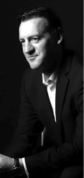 Black and white portrait of a man in a suit looking to the side