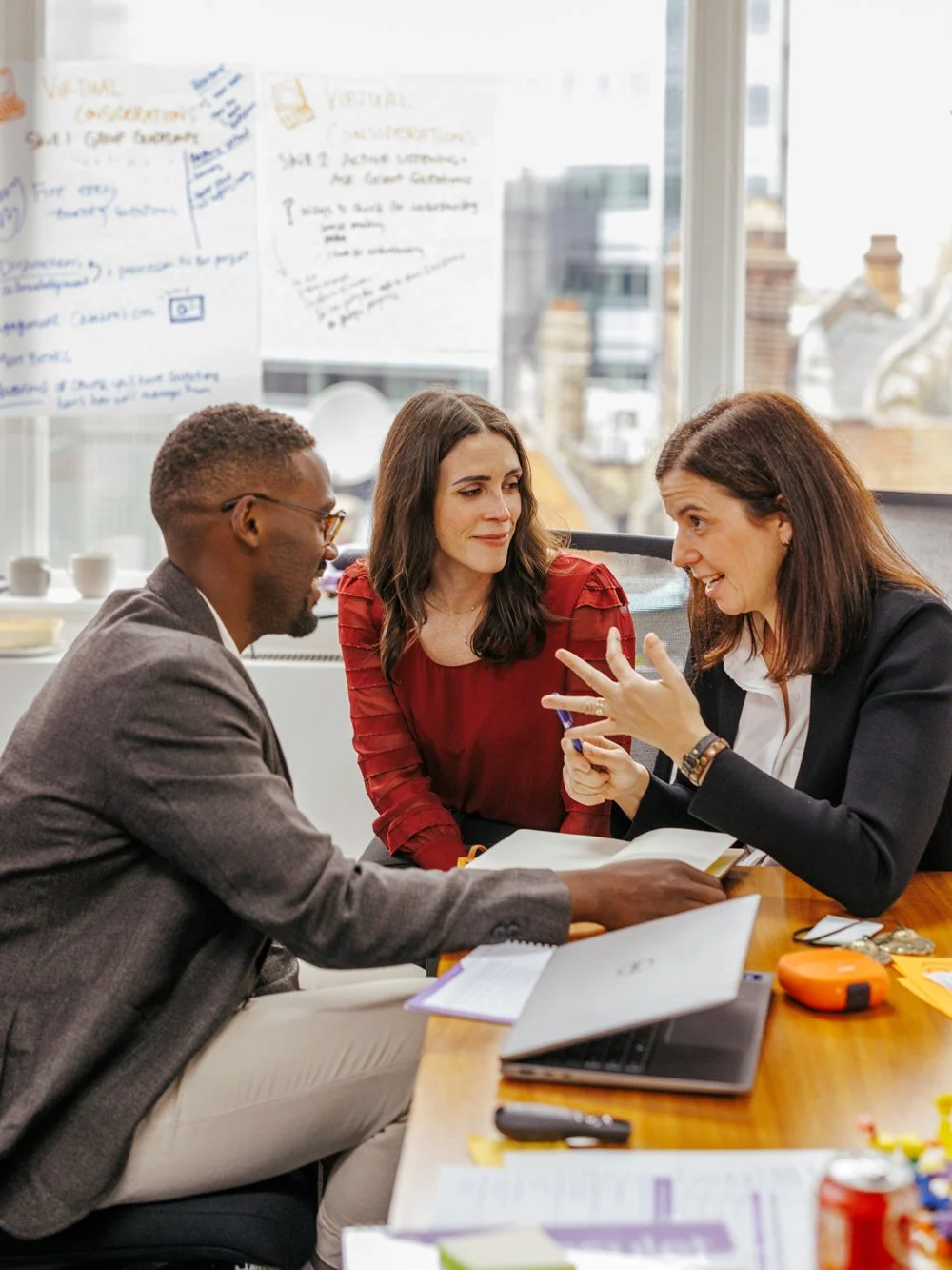 The team huddles to discuss the next steps while they provide consulting for nonprofits