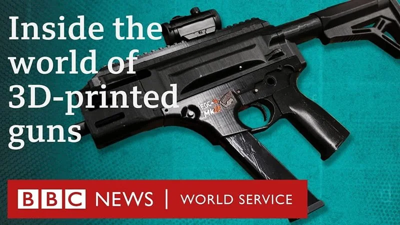 Close-up of a black 3D-printed gun on a teal background with white and red text from BBC News discussing 3D-printed guns.