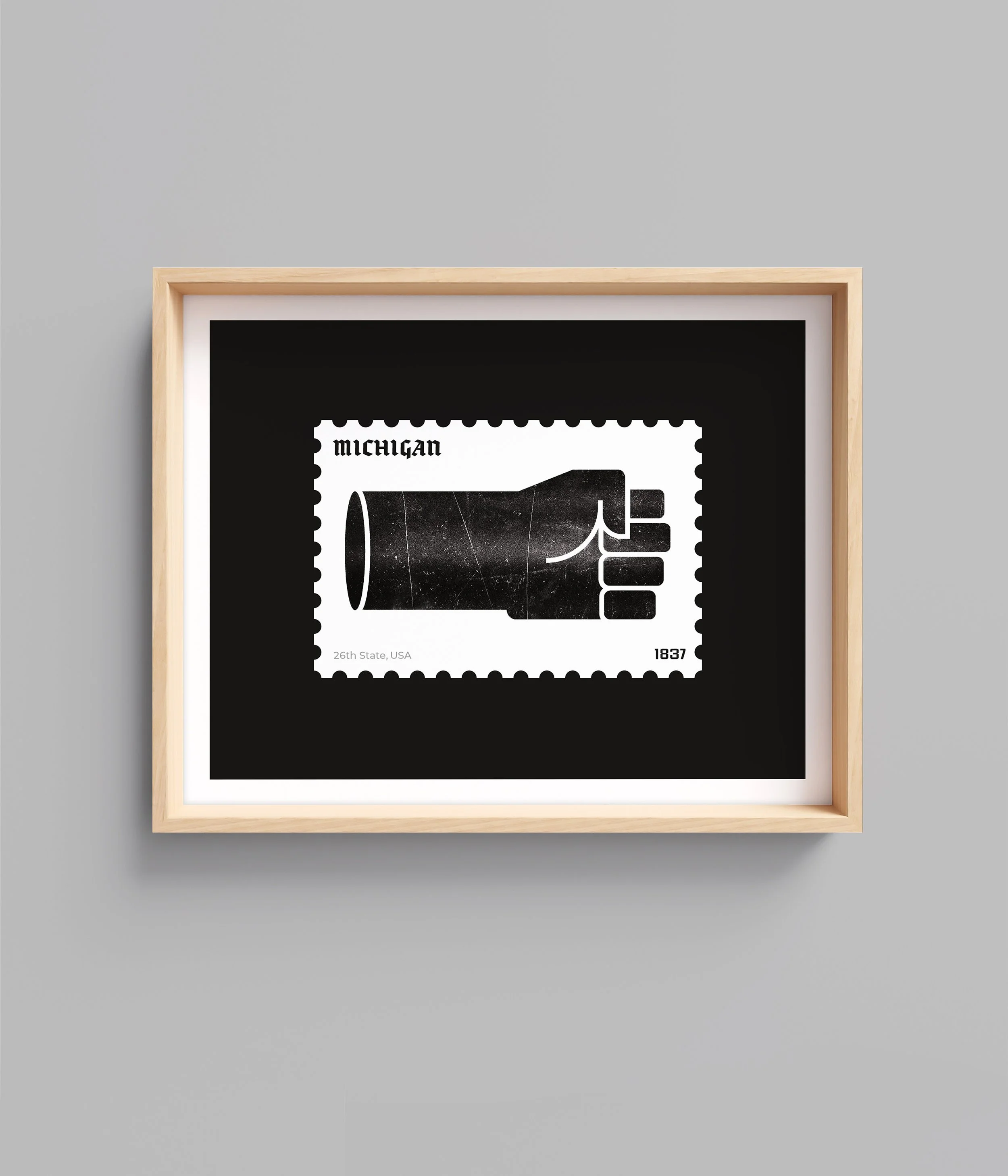A framed artwork of a stylized black-and-white postage stamp featuring a hand giving a thumbs up and the word 'Michigan' in the top left corner. The stamp includes text indicating '26th State, USA' at the bottom left and the year '1837' at the bottom