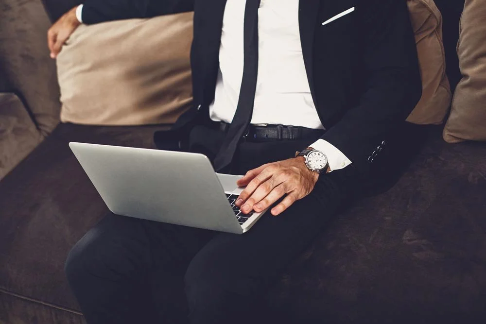 Professional man on laptop receiving suboxone treatment for opiod addiction in the privacy of his home