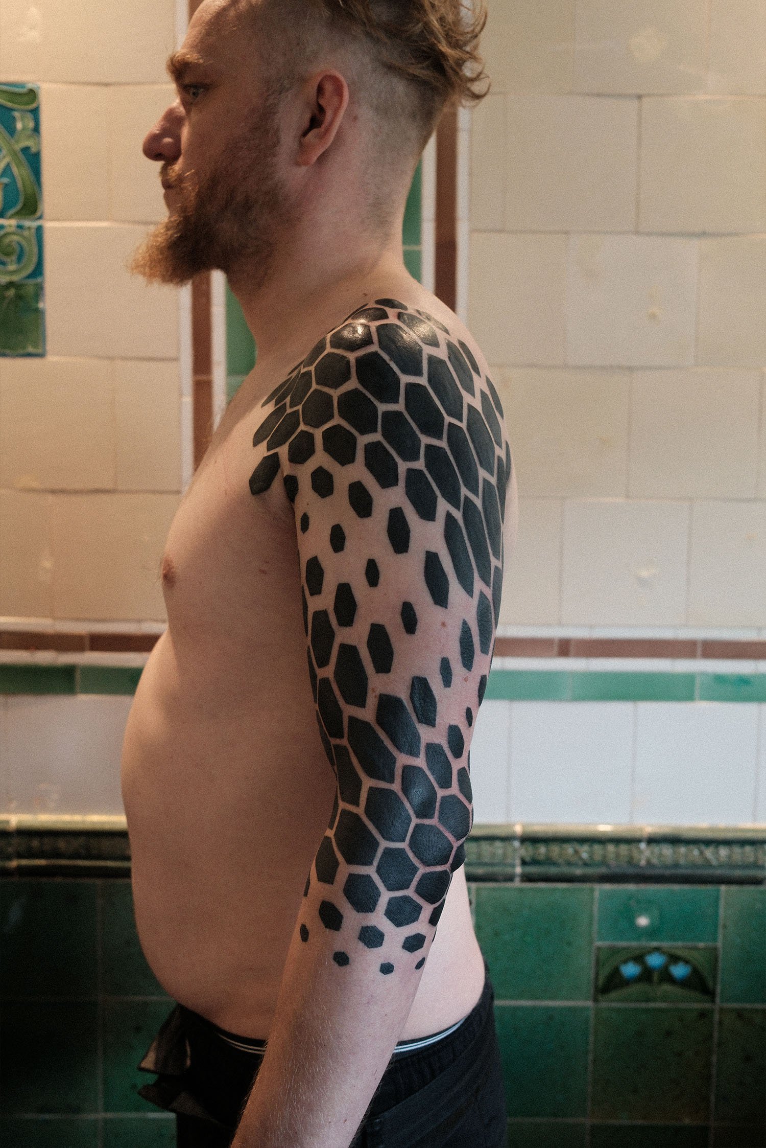 Hexagon blackwork sleeve tattoo