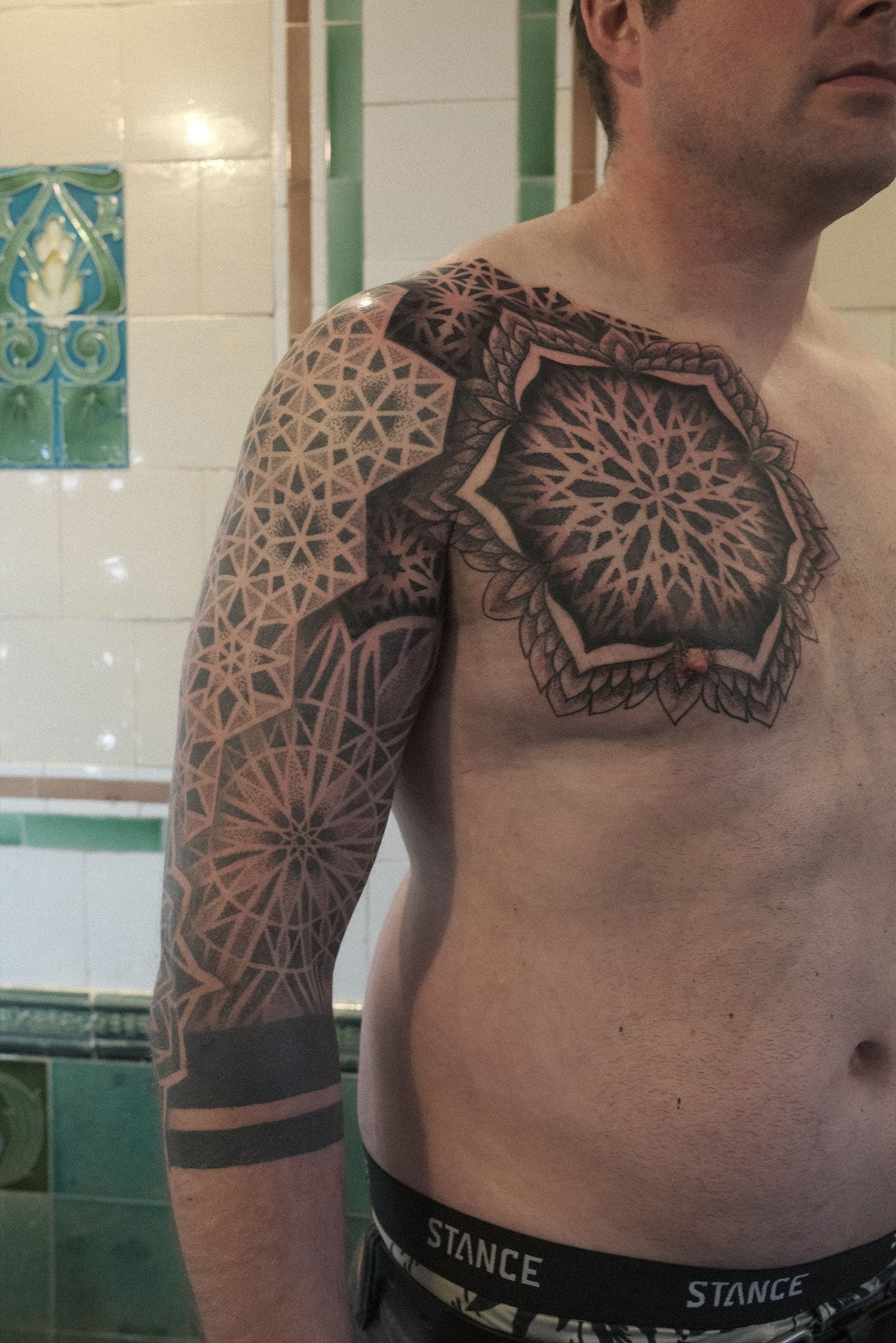 Geometric dotwork sleeve and chest mandala