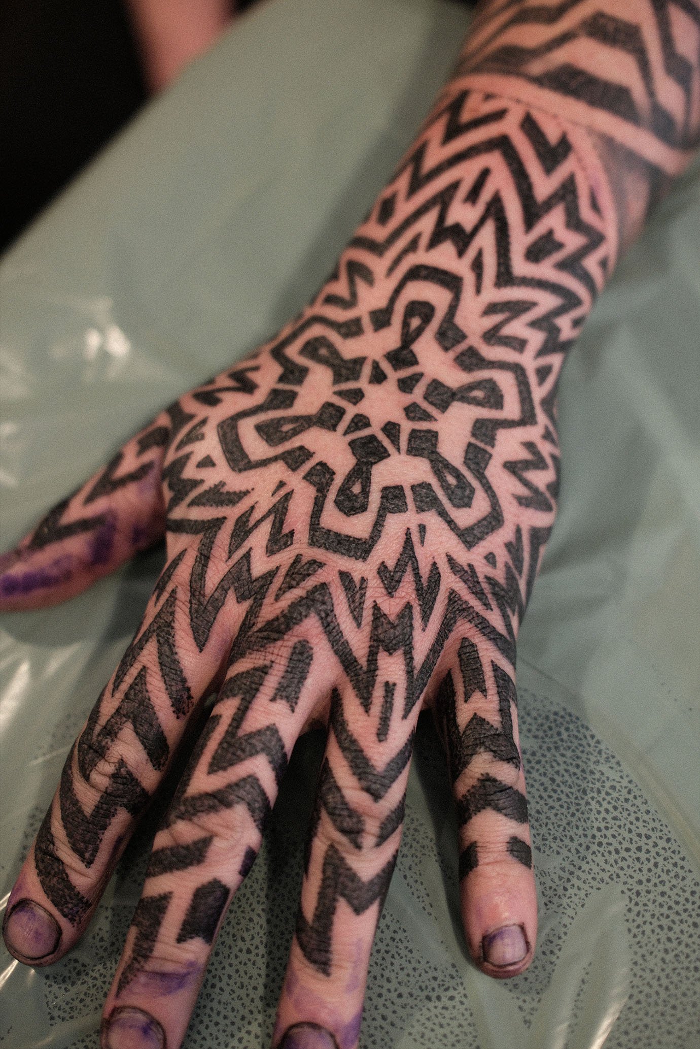 Geometric dotwork pattern hand tattoo