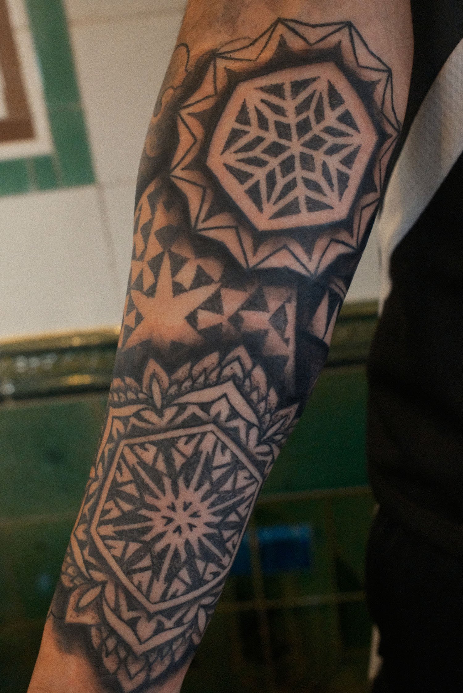 Geometric dotwork mandala tattoo