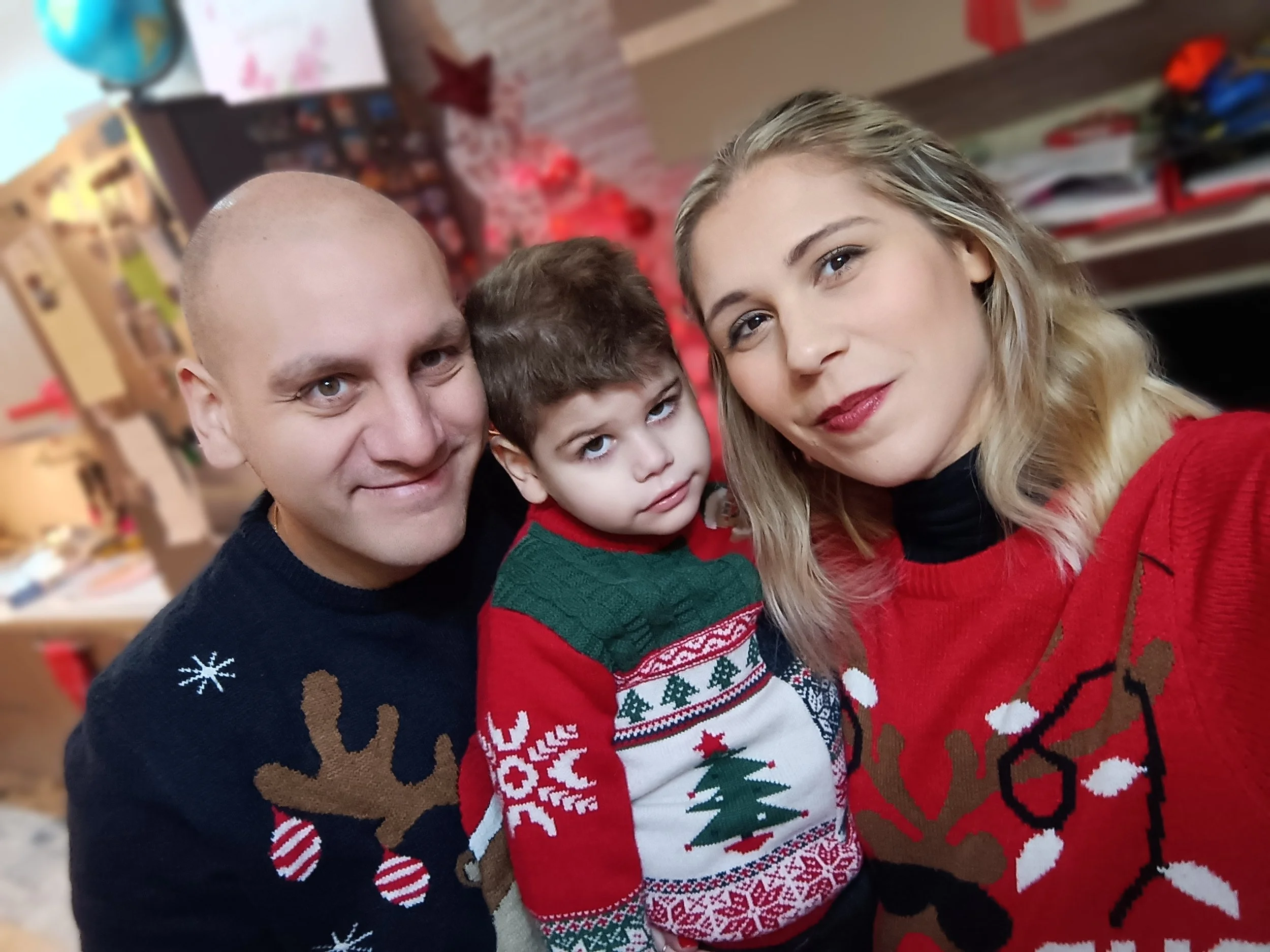 Picture shows the Lo Re family in Christmas jumpers - mum, dad and Gabriel