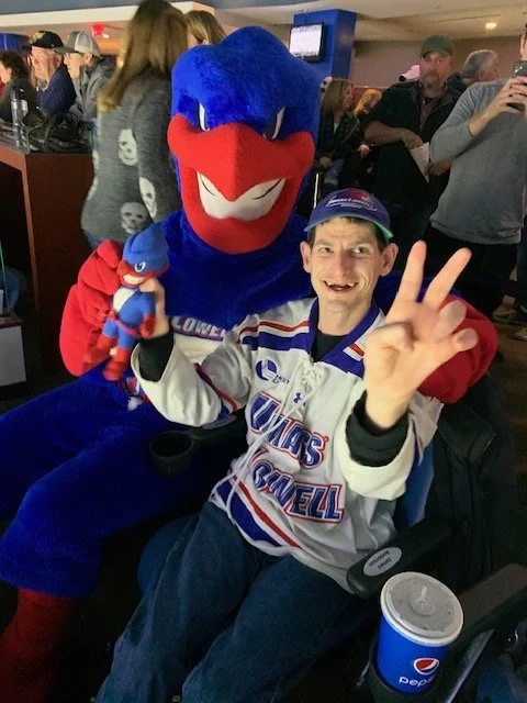 James Anderson  with mascot that is a blue bird with red beak