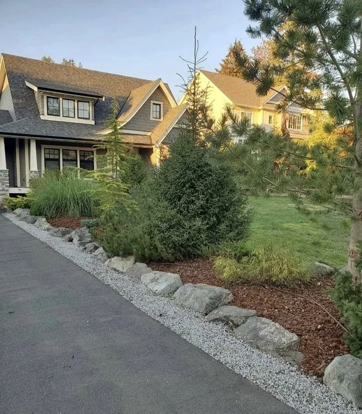 beautifully landscaped front garden with rock lining