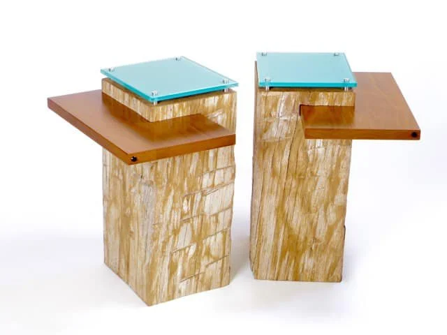 Two wooden pedestals showcasing custom painting techniques..