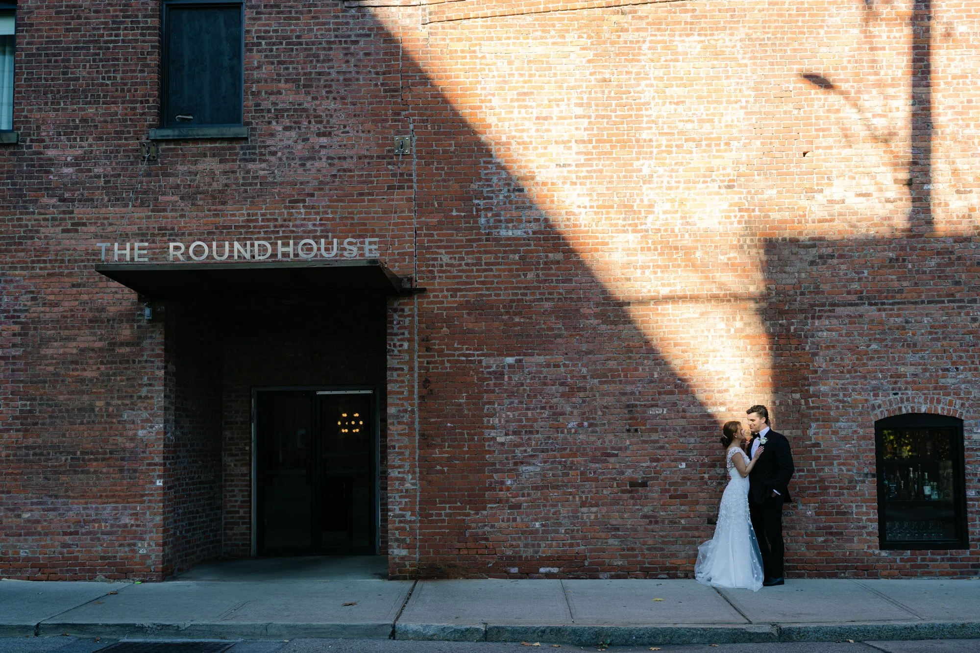 Couple posing in front of the Roundhouse Beacon sign