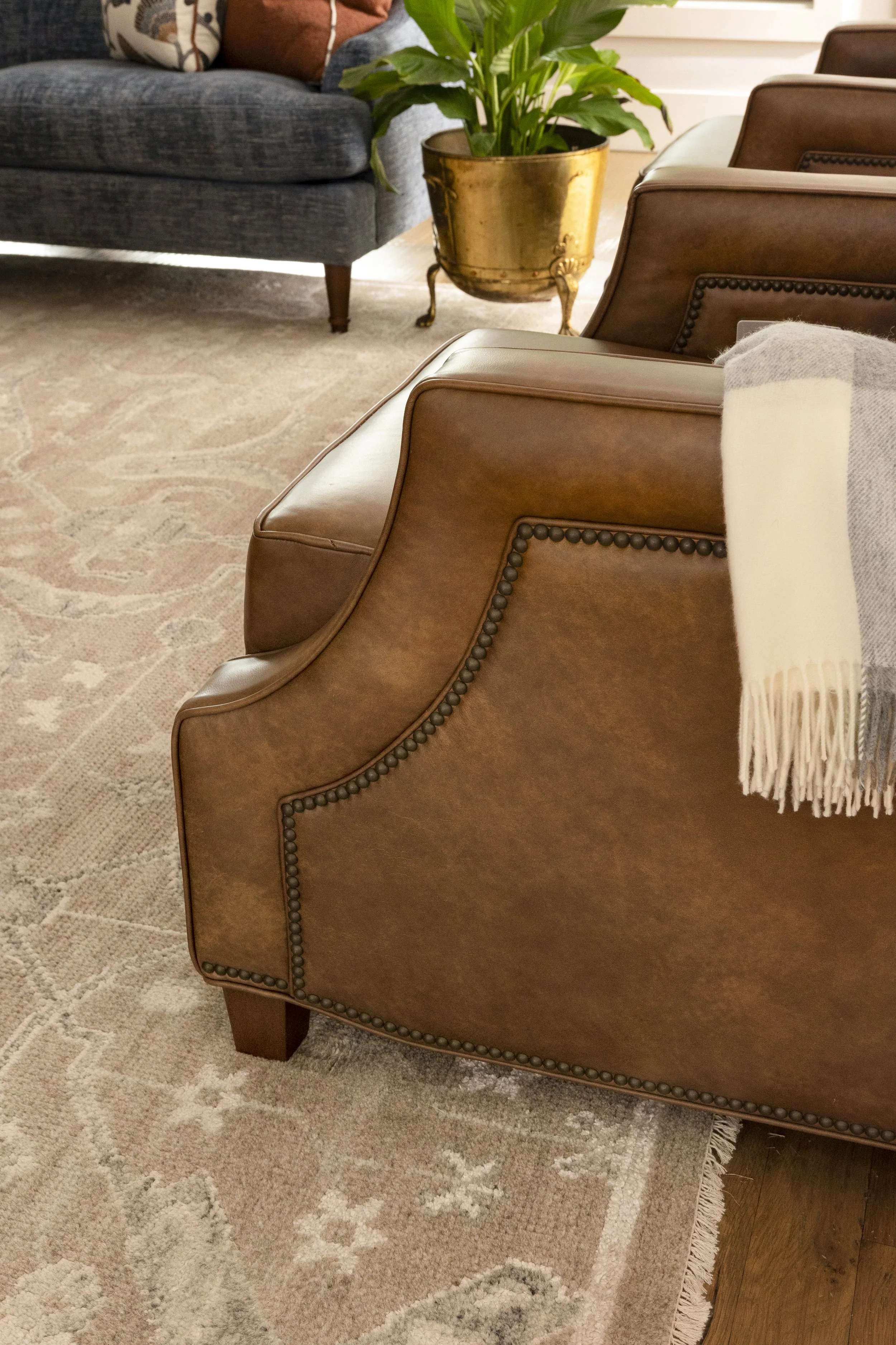 Rich leather, natural textures, and layered styling add warmth and character to this Dallas-Fort Worth area living room.