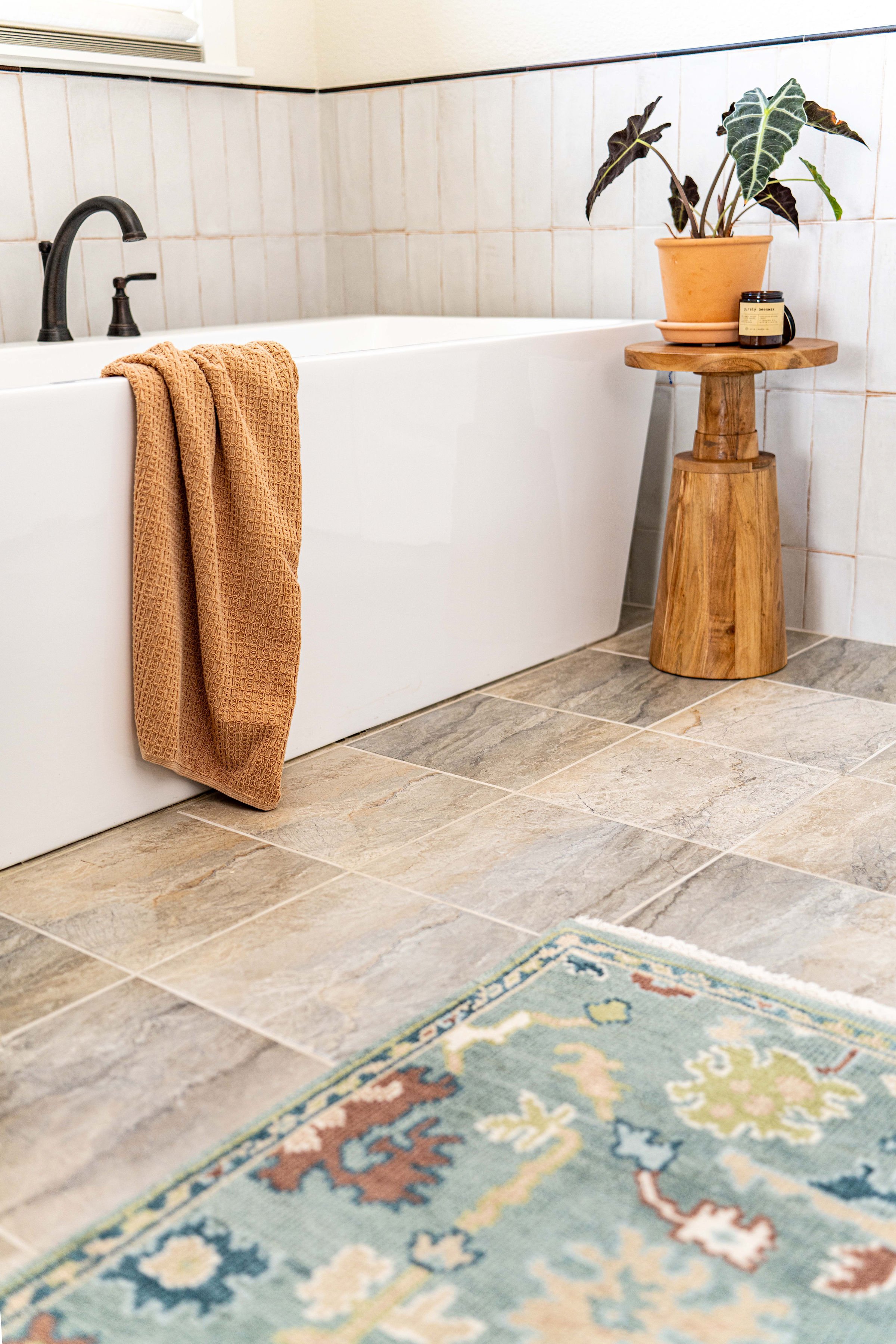 custom primary bathroom design with freestanding tub, neutral tile flooring, and modern fixtures in Argyle Texas