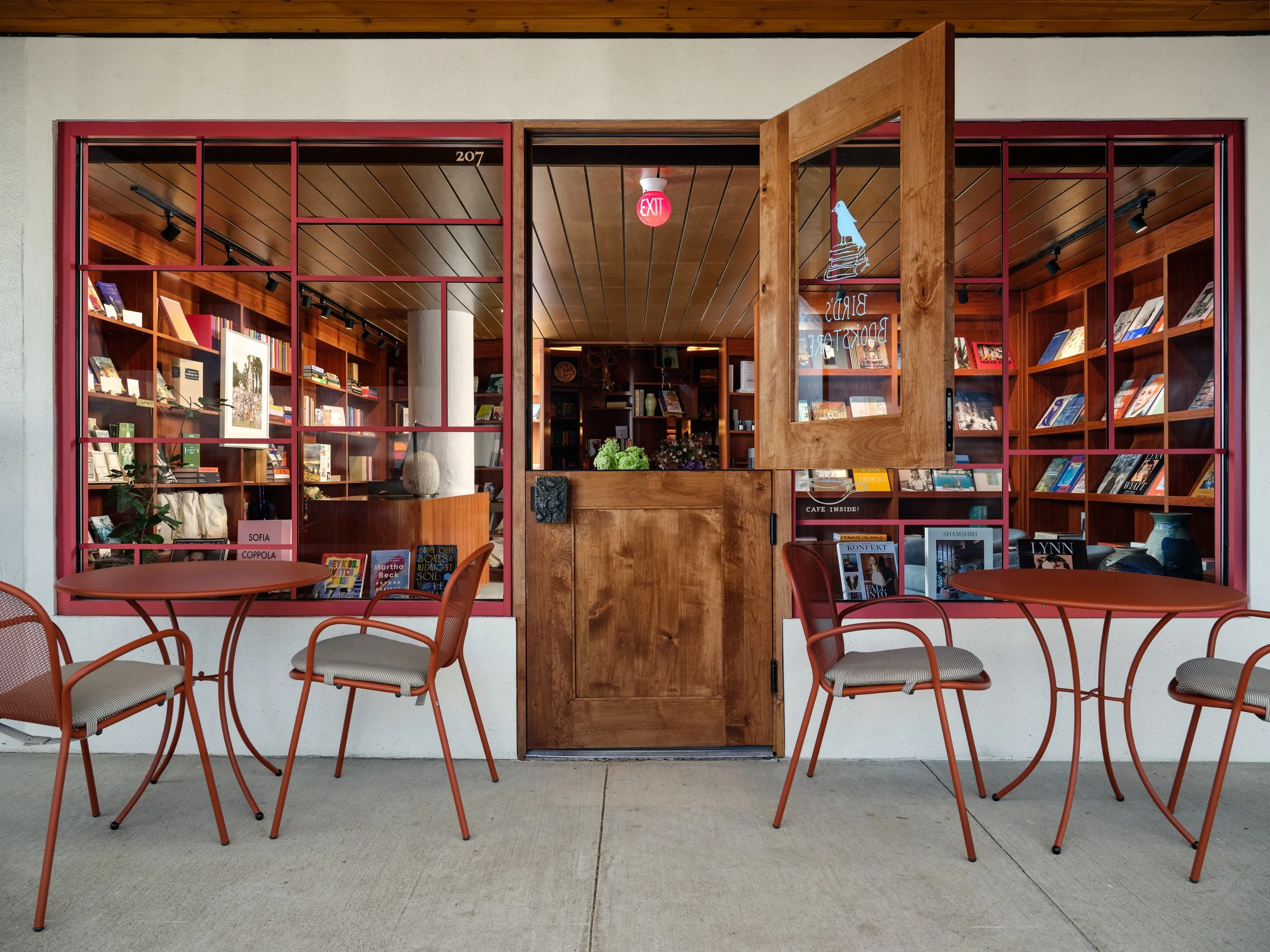 Image of Bird's Bookstore storefront with open dutch door and outdoor seating.