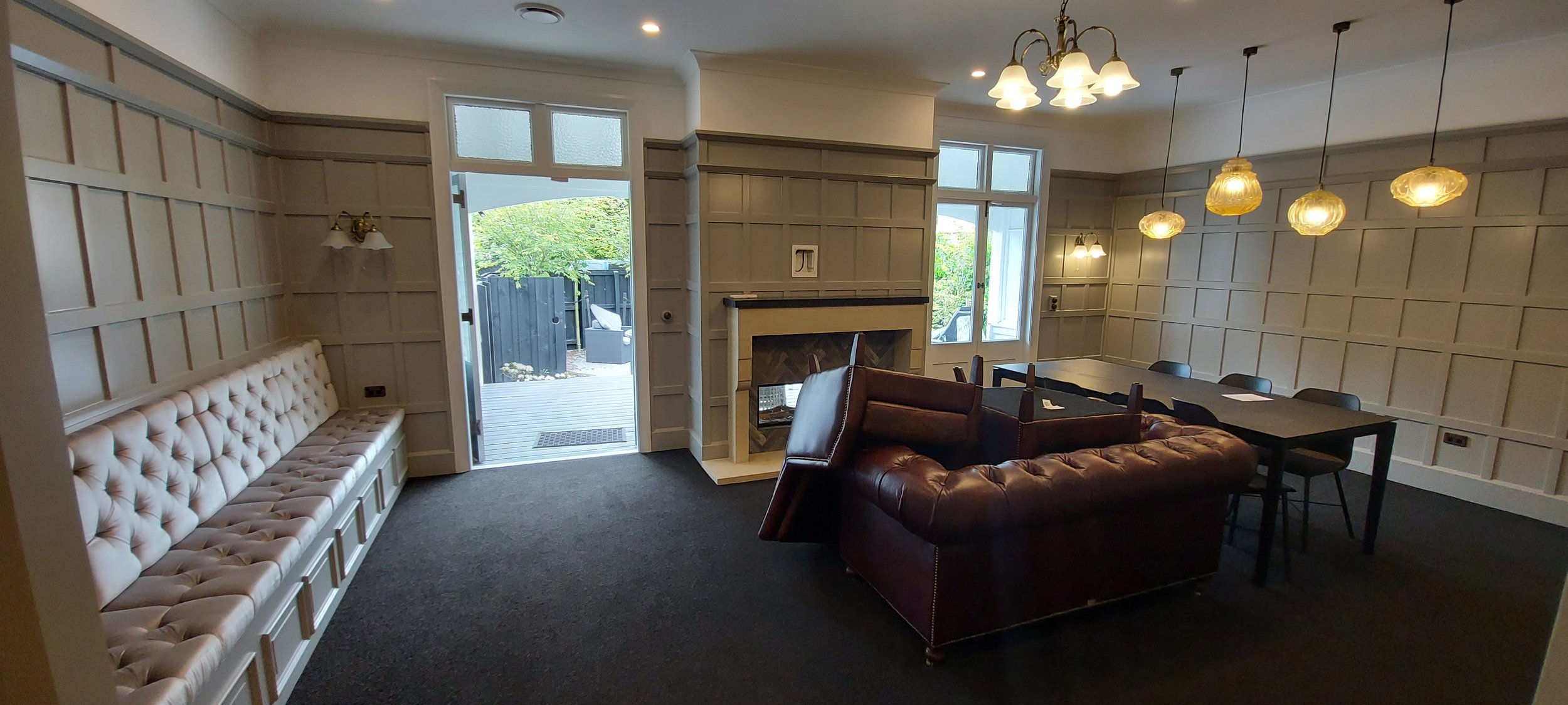 freshly painted office Interior of a room with paneled walls, featuring a fireplace, built-in bench seating in Christchurch