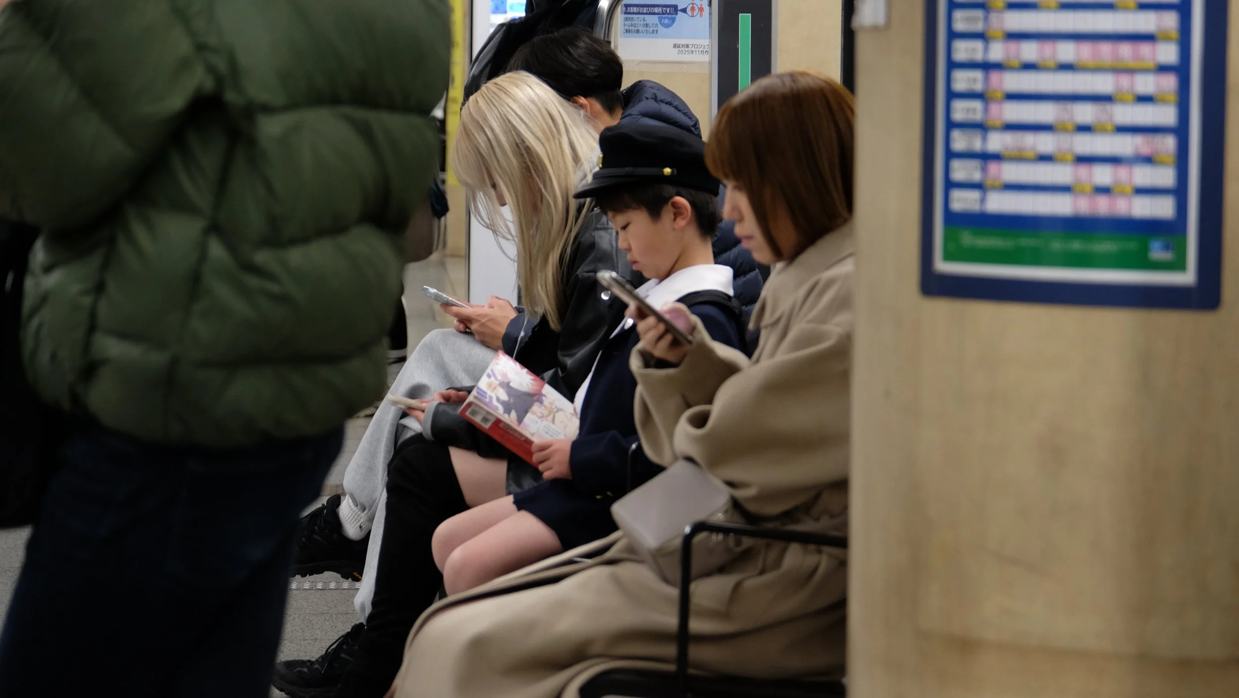 Young child reading manga on train