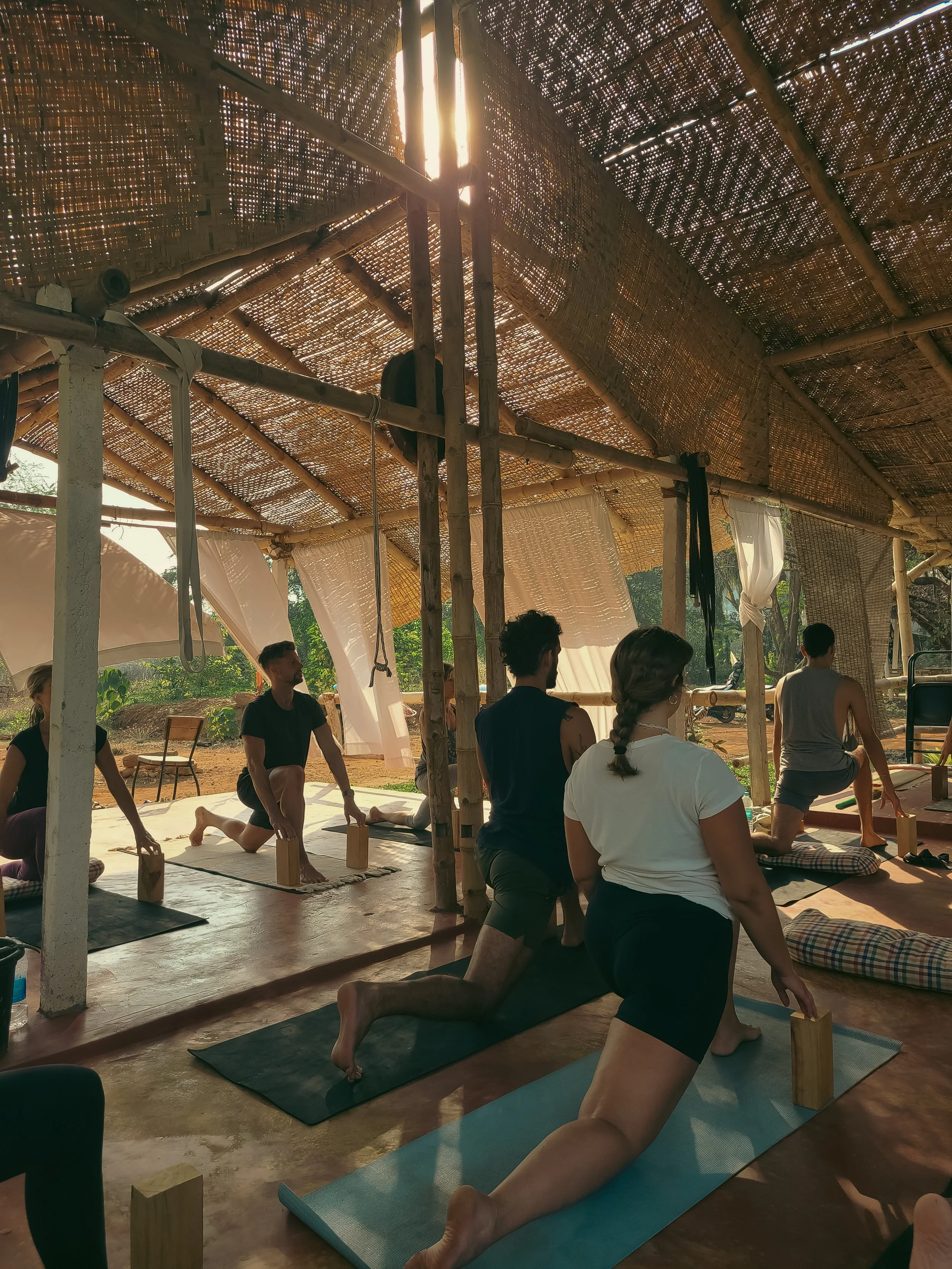 Hatha yoga practitioners using props for precise alignment at Yoga Mandir's shala in Palolem