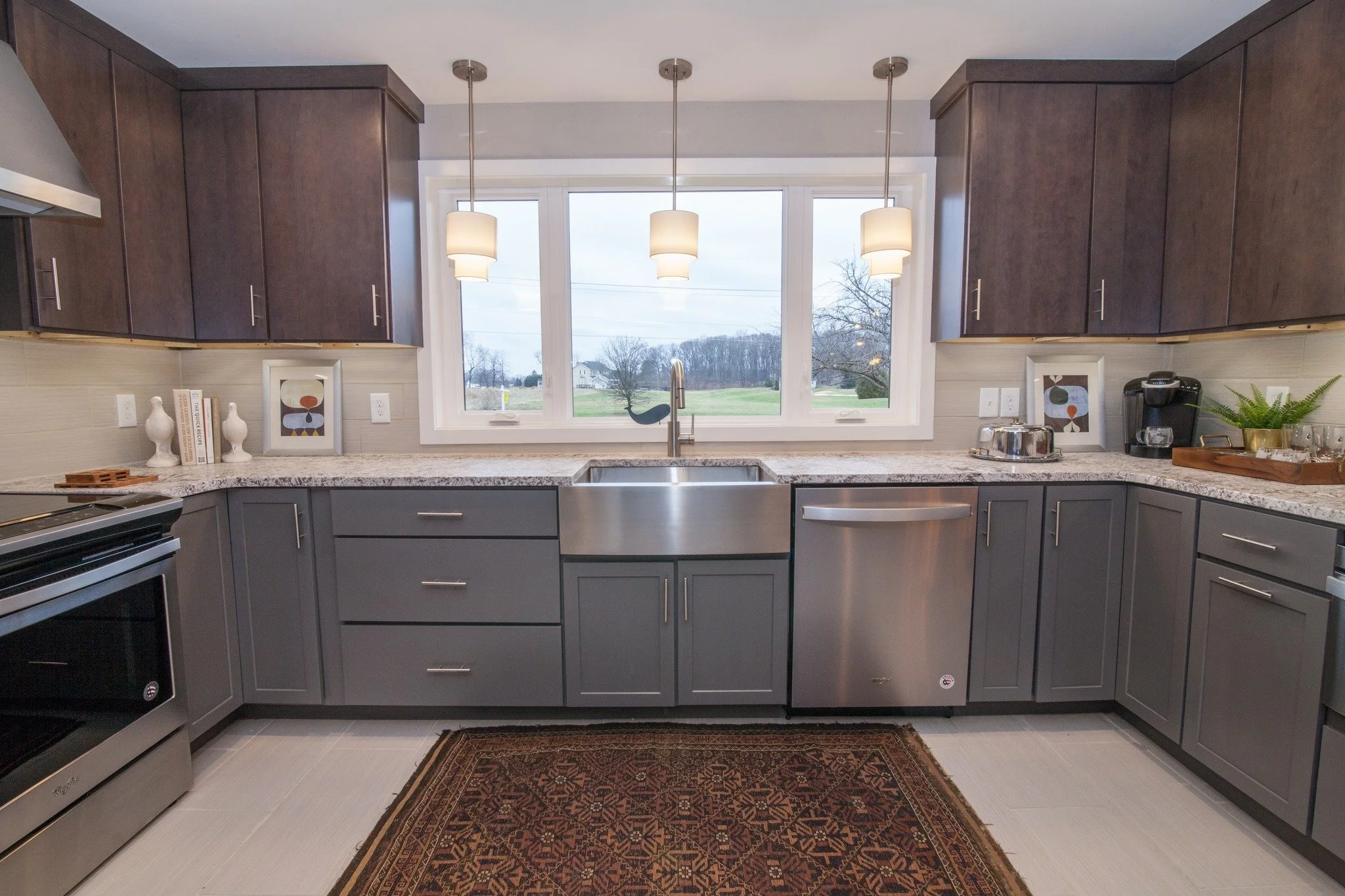 Harford County modern kitchen remodel with gray cabinets, granite countertops, stainless appliances, pendant lighting, and open, inviting design.
