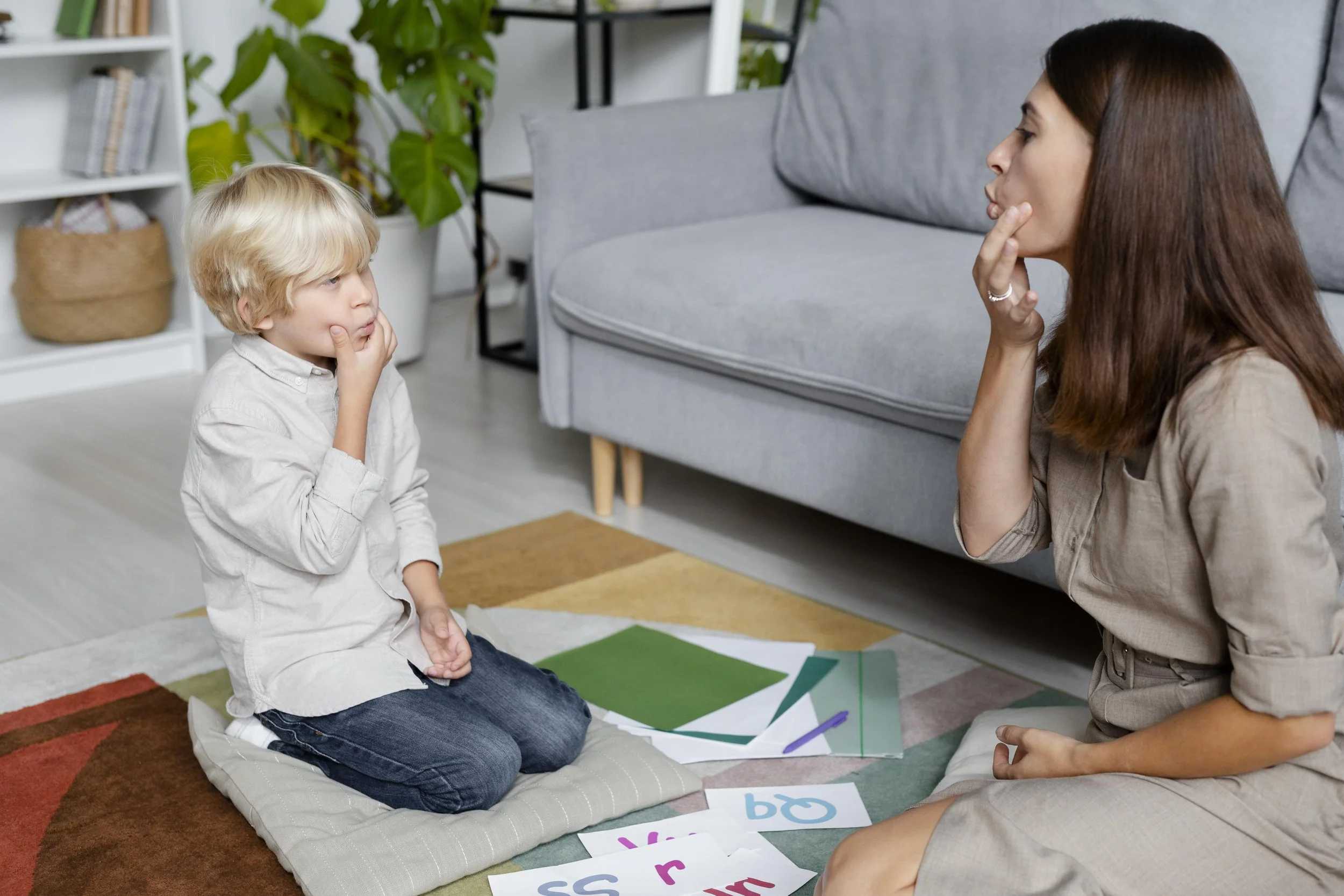 young-woman-doing-speech-therapy-with-little-boy.jpg